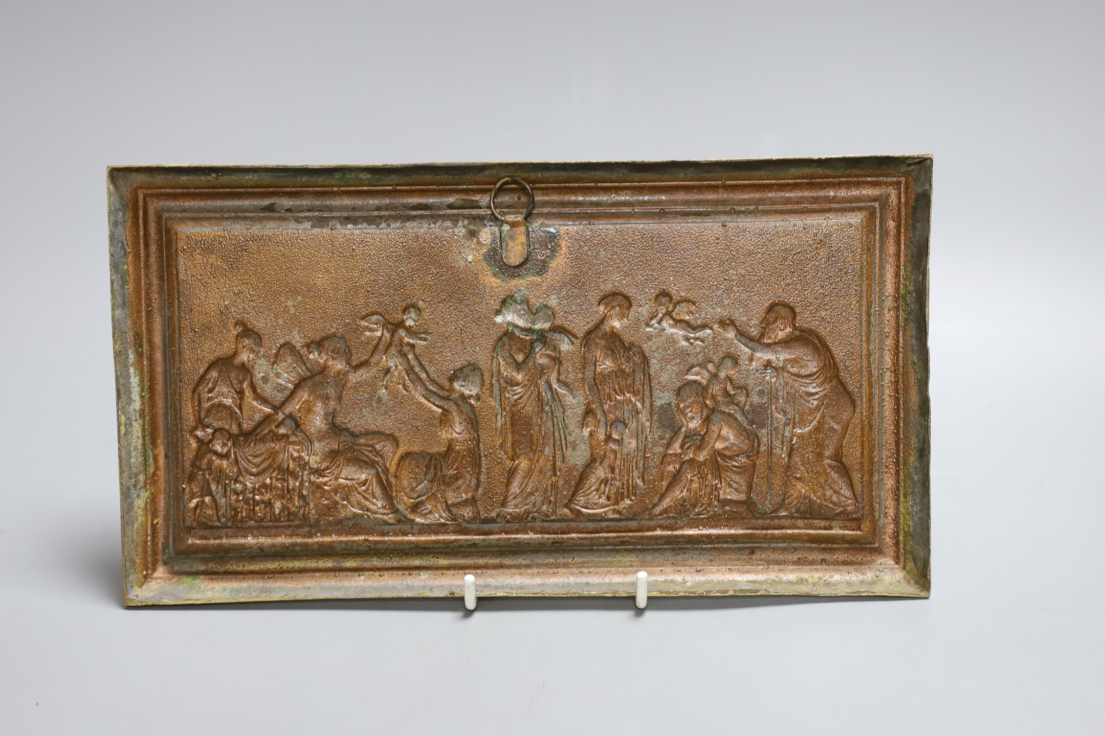 A gilt metal plaque depicting a classical scene, 15x27cm